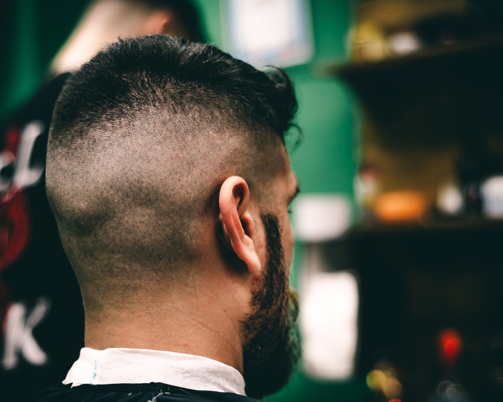 A relaxed client after a fresh fade and beard trim (sample image, replace with a real photo)